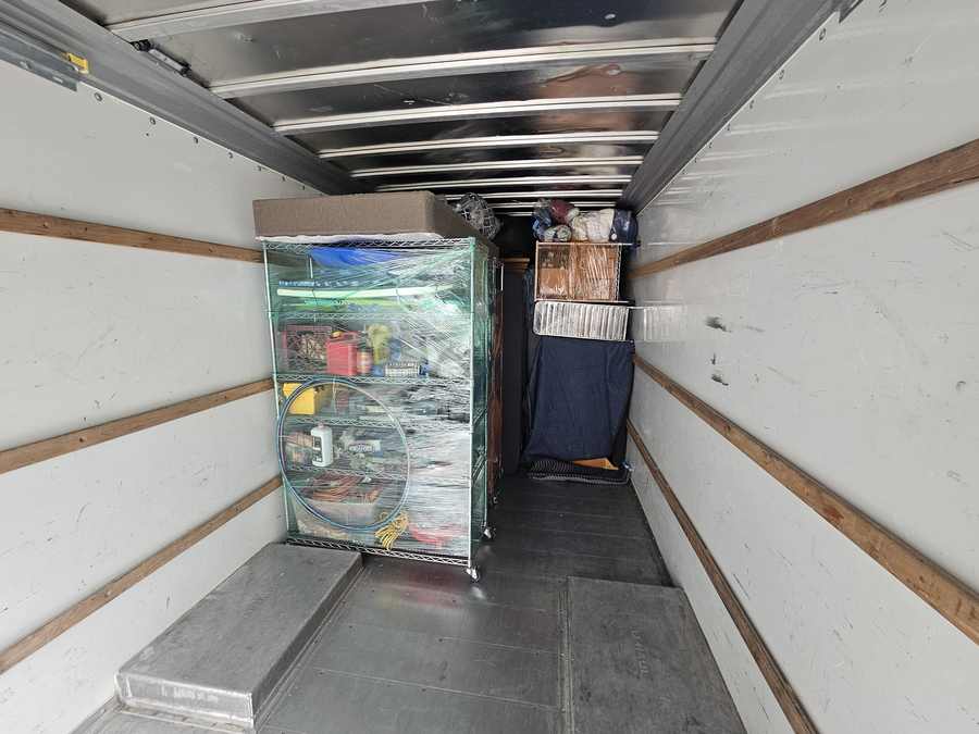 Wrapped furniture and belongings secured inside a VarCity moving truck