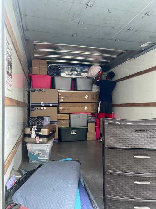 Packed moving truck with boxes and protected furniture